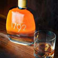 Load image into Gallery viewer, Bottle of 1792 bourbon with a glass of whiskey on a wooden surface