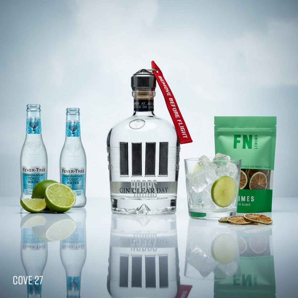 Load image into Gallery viewer, Bottle of 4 Bars Gin Clear Day with Fever-Tree tonic water, lime slices, and a glass on a reflective surface.