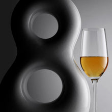 Load image into Gallery viewer, A tequila tasting glass with tequila inside next to a bottle of 818 Eight Reserve Anejo Tequila on a gray background