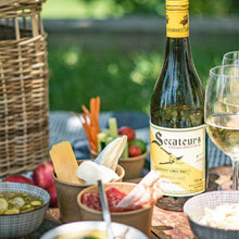 Load image into Gallery viewer, Secateurs Chenin Blanc wine bottle with outdoor setting and food items on a table