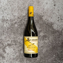 Load image into Gallery viewer, Wine bottle with yellow label on a textured gray background
