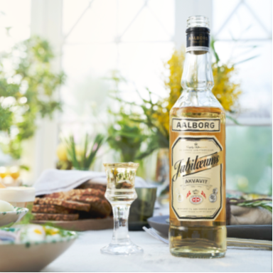 Aalborg bottle of schnapps on a table with a blurred background