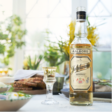 Load image into Gallery viewer, Aalborg bottle of schnapps on a table with a blurred background