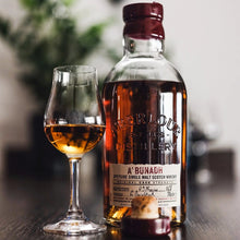 Load image into Gallery viewer, Bottle of  Aberlour Abunadh whisky and a glass with whisky on a wooden surface.