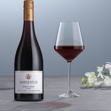 Load image into Gallery viewer, Amisfield Pinot Noir wine bottle with a glass of red wine on a gray surface with white flowers.