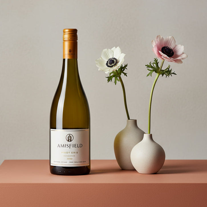 Load image into Gallery viewer, Amisfield Pinot Gris wine bottle with two vases containing flowers on a table