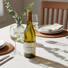 Load image into Gallery viewer, Amisfield Sauvignon Blanc wine bottle on a table with glasses and plates