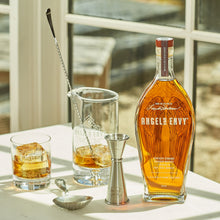 Load image into Gallery viewer, Angel &amp; Envy bourbon bottle with glasses and bar tools on a table.