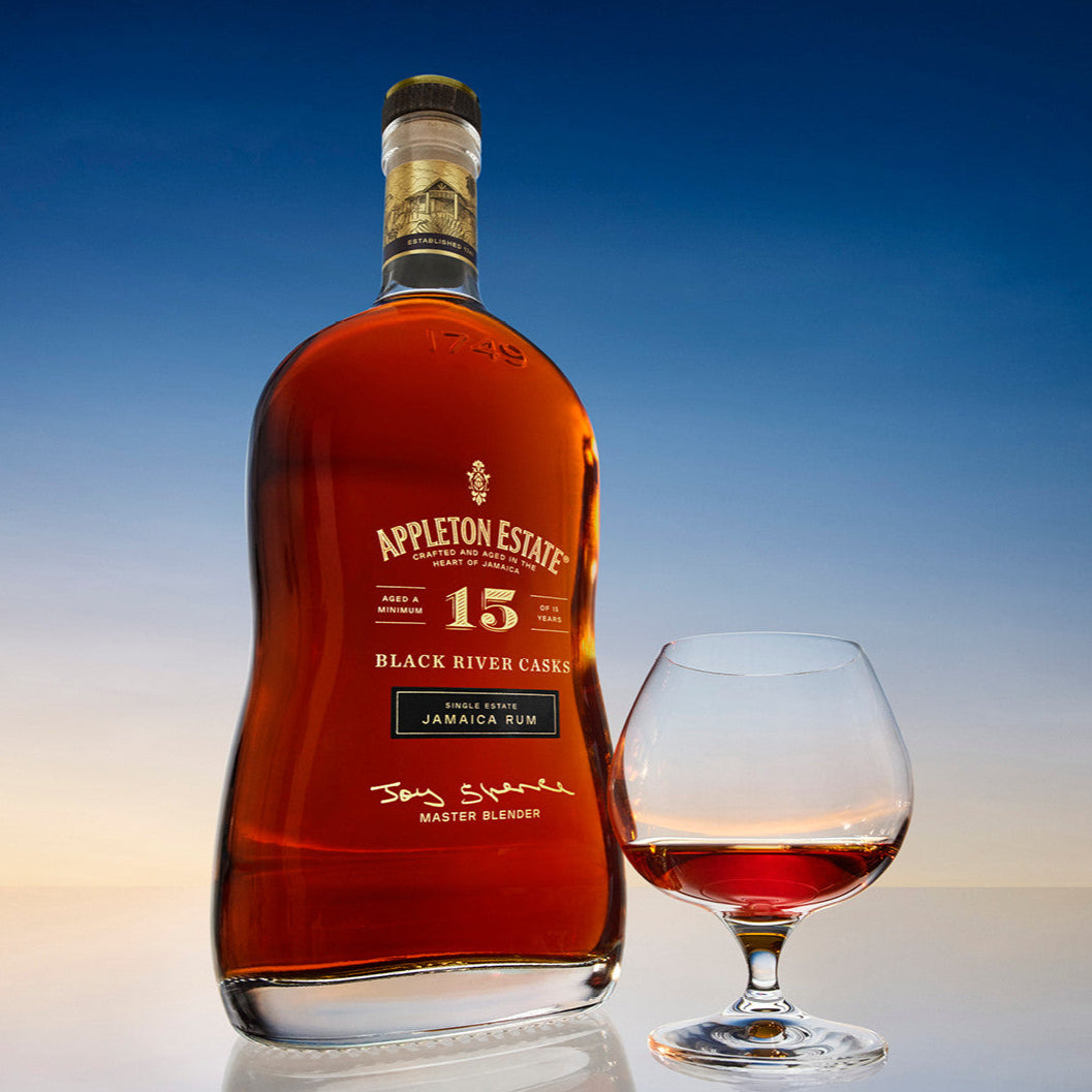 Load image into Gallery viewer, Bottle of Appleton Estate 15-year-old rum with a glass of rum on a gradient background