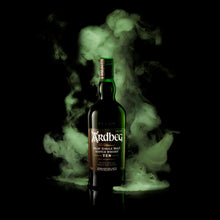 Load image into Gallery viewer, Ardbeg 10 year old whisky bottle with green smoke on a black background