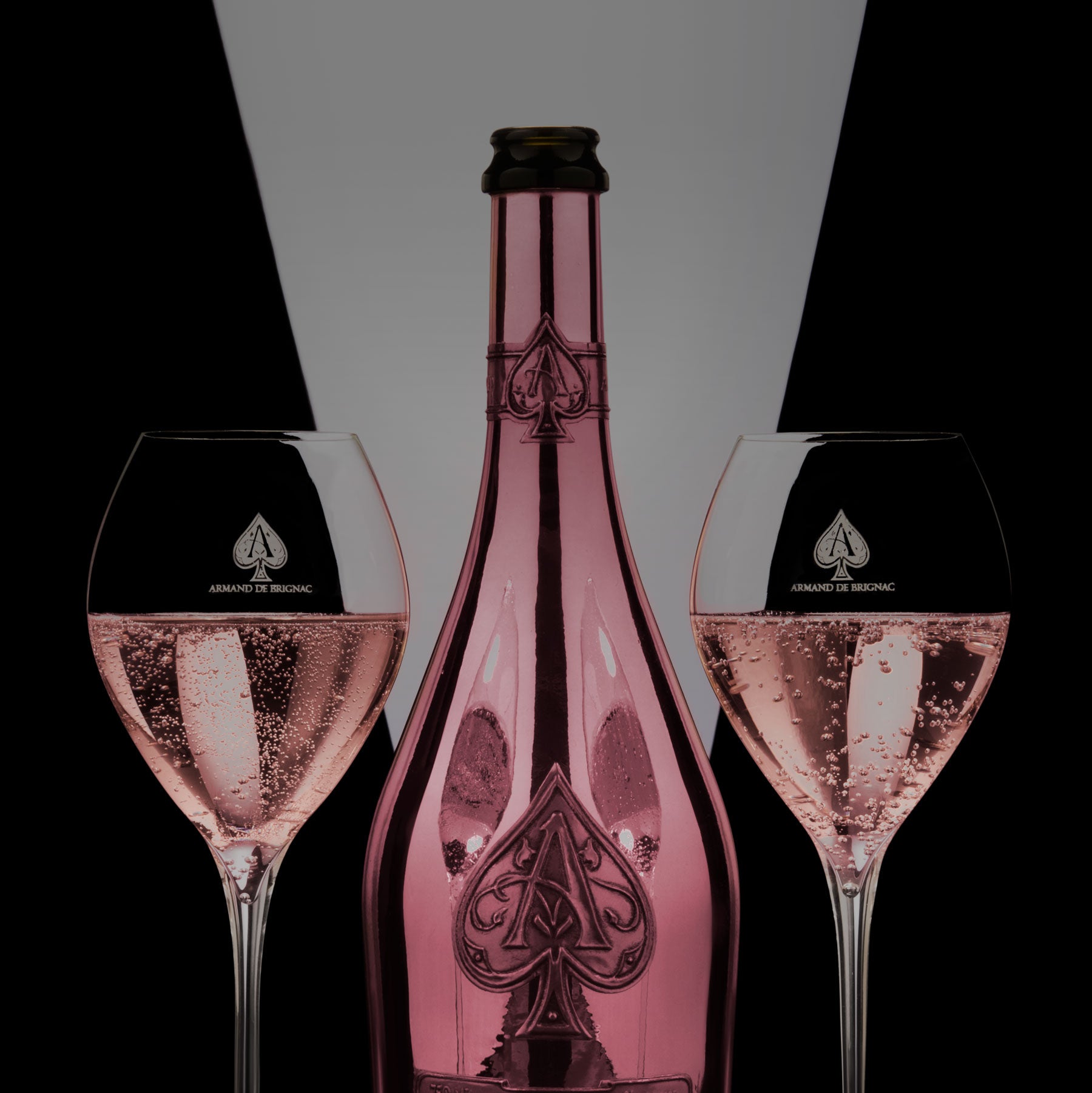 Load image into Gallery viewer, A bottle of Armand de Brignac Ace of Spades Rosé Champagne with two half filled champagne flutes beside it
