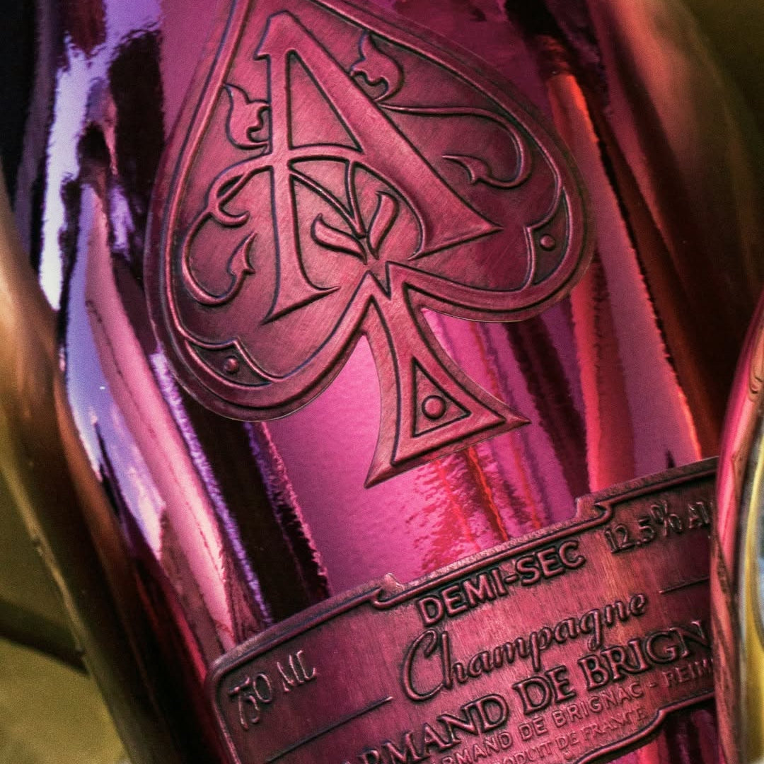 Load image into Gallery viewer, Close up image of the metallic label of a pink bottle of Armand de Brignac Ace of Spades Rosé Champagne.