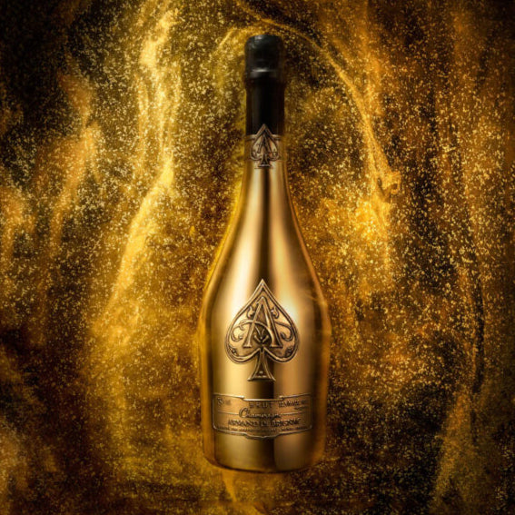 Load image into Gallery viewer, Gold bottle with black cap on a textured gold background