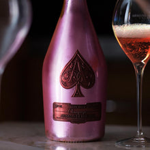 Load image into Gallery viewer, Pink champagne bottle with a spade symbol and a glass of champagne on a dark background