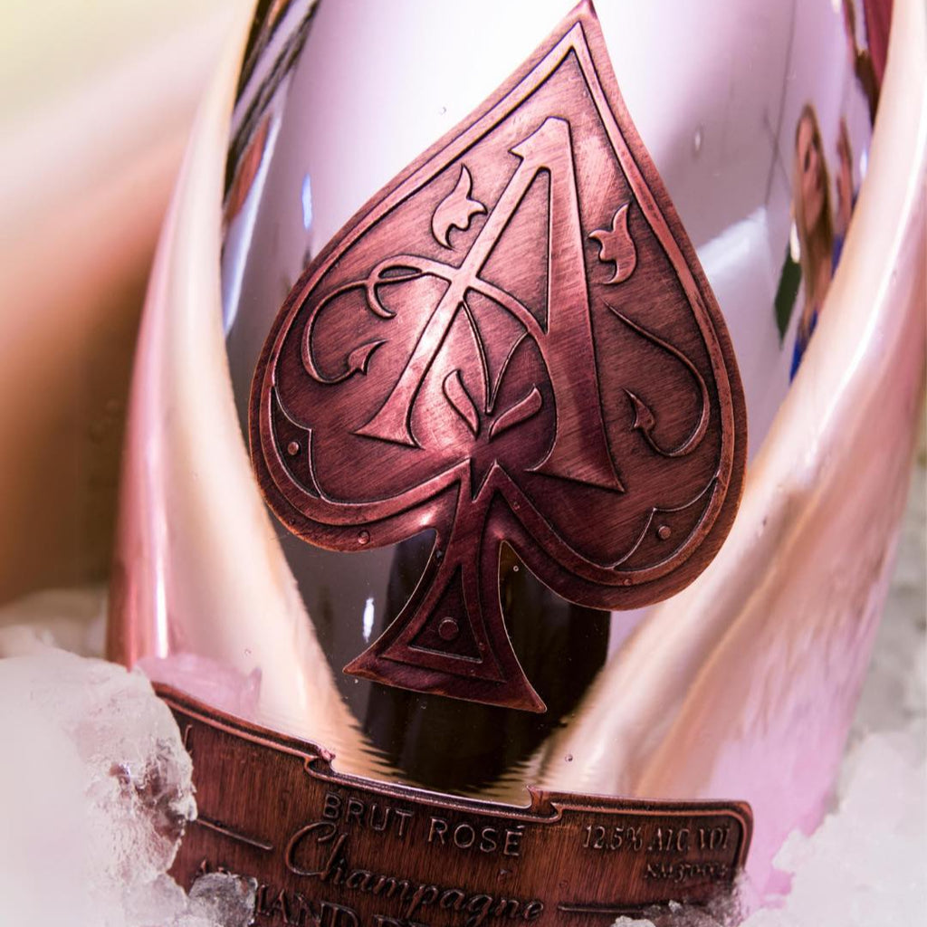 Champagne bottle with a spade logo on a bed of ice
