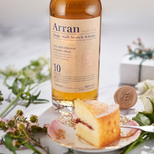 Load image into Gallery viewer, Arran 10 year old single malt Scotch whisky bottle with a slice of cake on a decorative plate.
