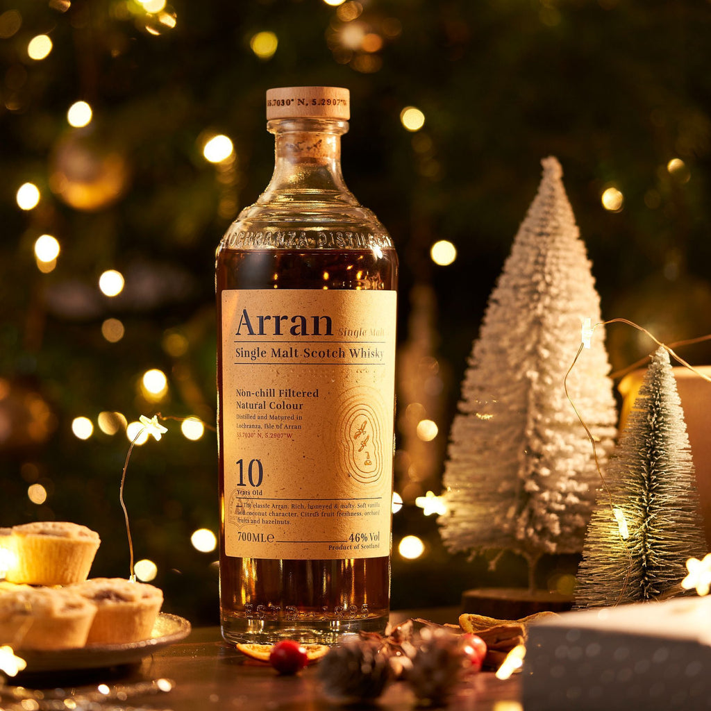 Arran 10 year old whisky bottle with Christmas decorations in the background