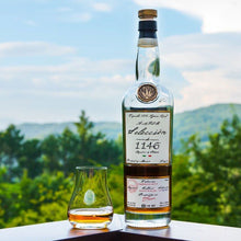 Load image into Gallery viewer, Bottle and glass of ArteNOM-Seleccion-de-1146-Anejo-Tequila 1146 with a scenic background