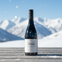 Load image into Gallery viewer, Auntsfield-Single-Vineyard-Pinot-Noir- wine bottle on a snowy surface with mountains in the background