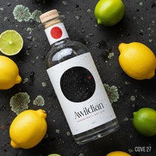 Load image into Gallery viewer, Bottle of Awildian Coromandel Dry gin surrounded by lemons and limes on a dark surface