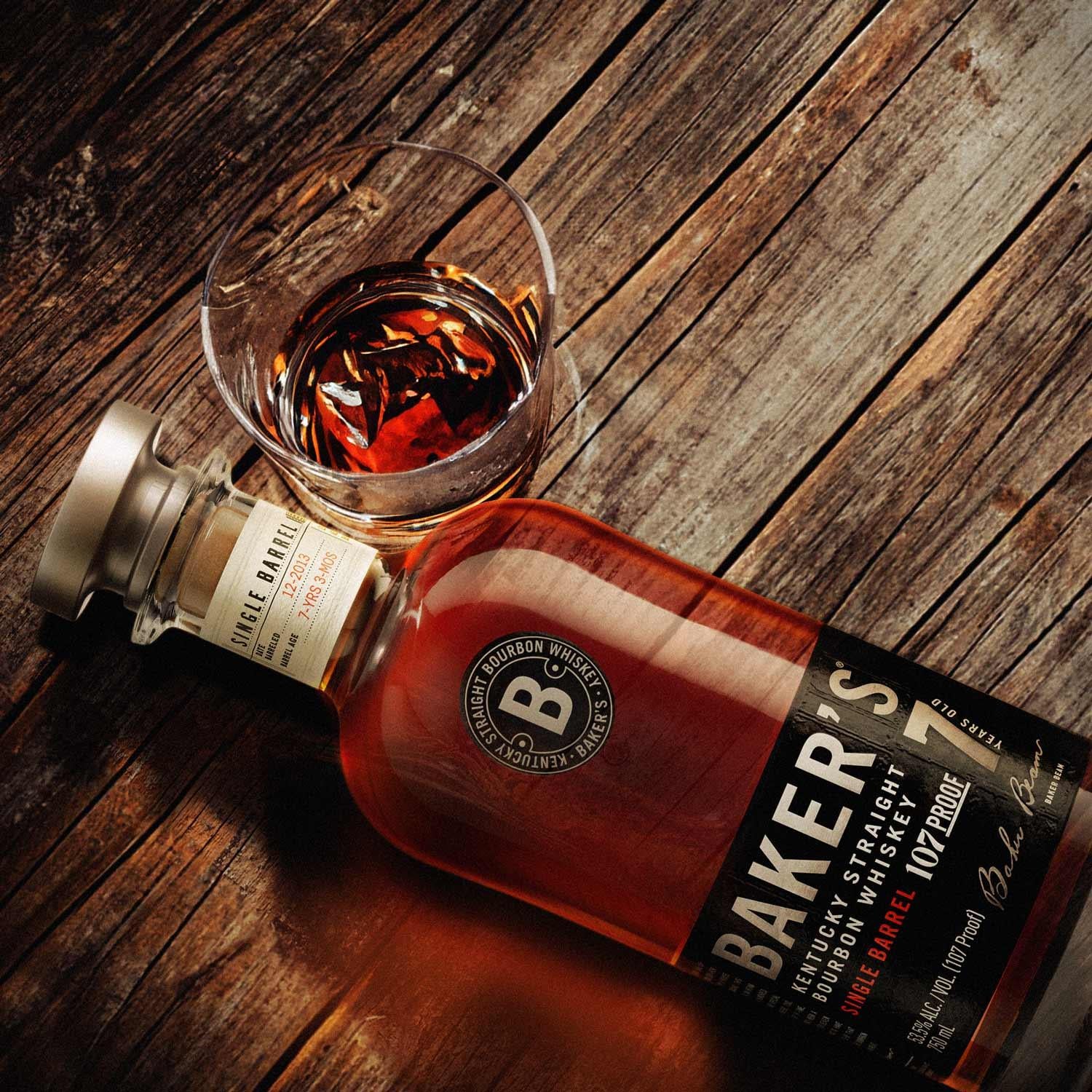 Load image into Gallery viewer, Baker's bourbon whiskey bottle and glass on a wooden surface