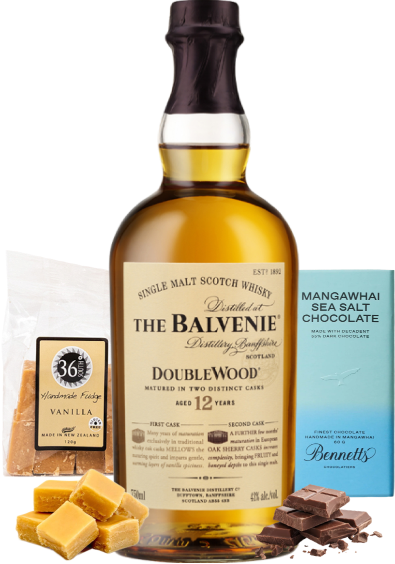 Load image into Gallery viewer, A bottle of The Balvenie DoubleWood 12yo single malt Scotch whisky is centred, flanked by a bag of 36 Degrees Handcrafted Vanilla fudge, a blue box of Bennetts Mangawhai Sea Salt Chocolate, and caramel and dark chocolate pieces on a white background.