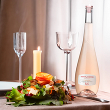 Load image into Gallery viewer, Bottle of Barton &amp; Guestier rosé wine with a candle and salad on a table.