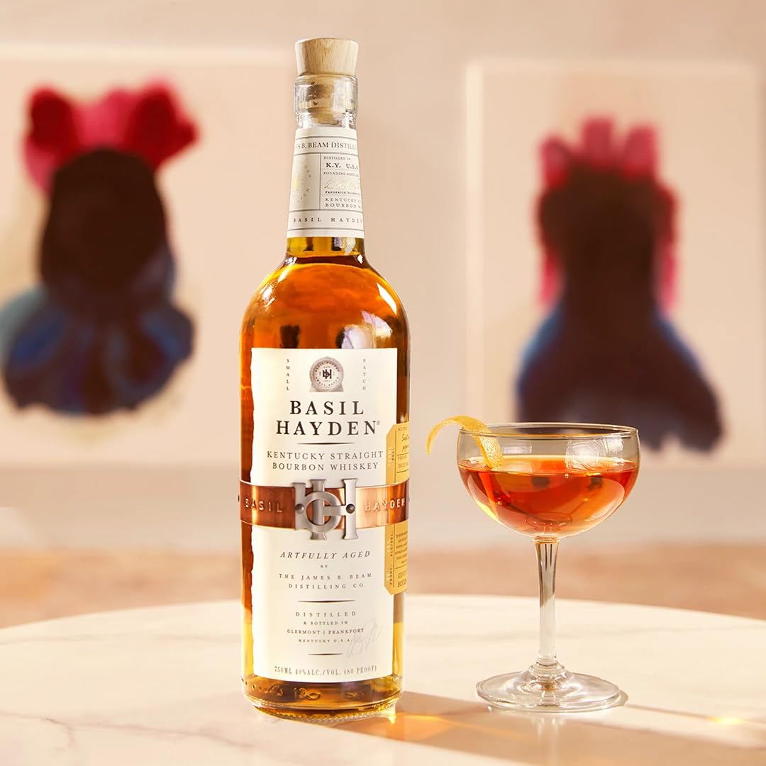 Load image into Gallery viewer, Bottle of Basil Hayden bourbon whiskey with a cocktail glass on a table.
