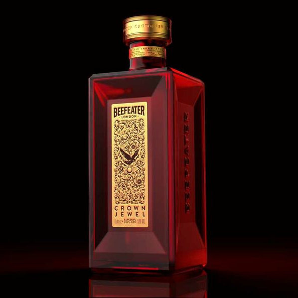 Load image into Gallery viewer, Beefeater Crown Jewel Gin bottle with gold label on a black background