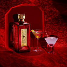 Load image into Gallery viewer, Ultra-premium bottle of Beefeater Crown Jewel Gin on a red background with two cocktails.