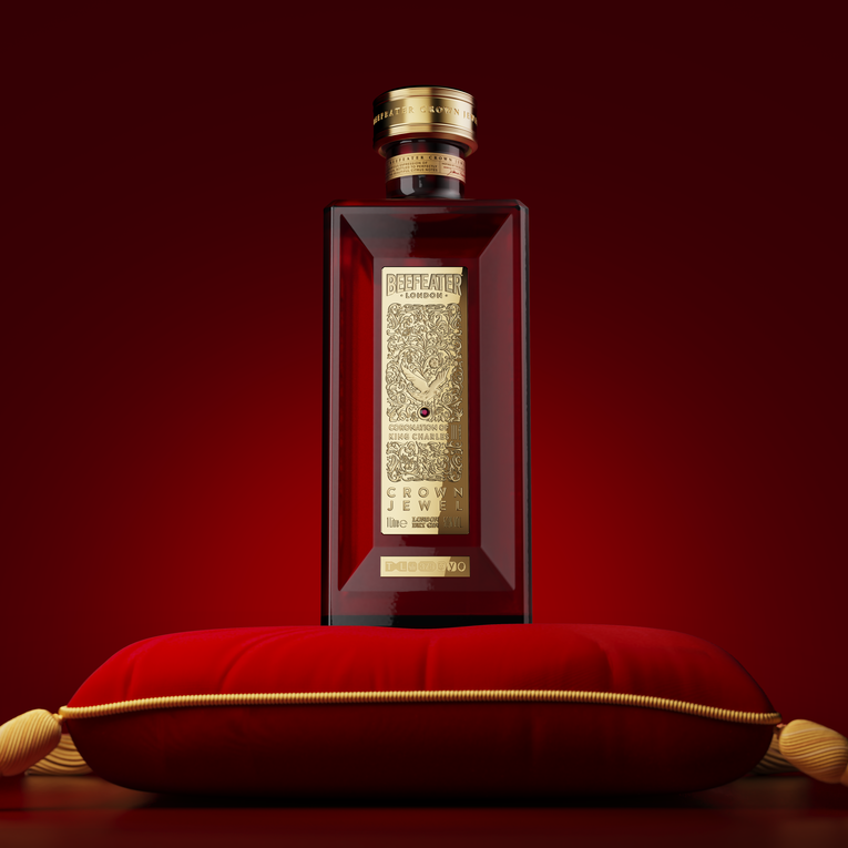 Load image into Gallery viewer, Luxury bottle of Beefeater Crown Jewel Gin on a red cushion against a red background