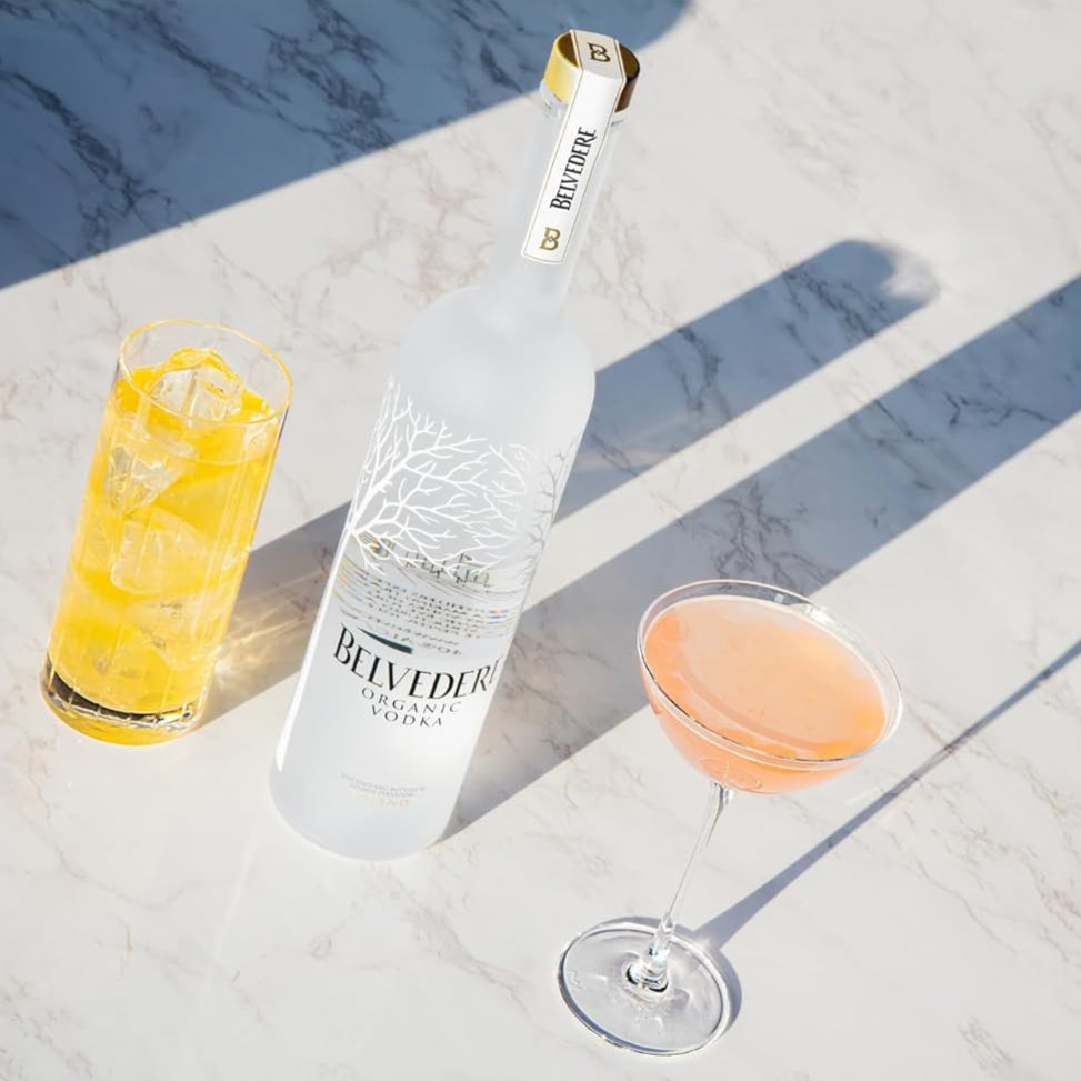 Bottle of Belvedere vodka with two cocktails on a marble surface