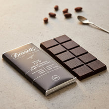 Load image into Gallery viewer, Bennett&#39;s dark chocolate bar with packaging on a concrete surface