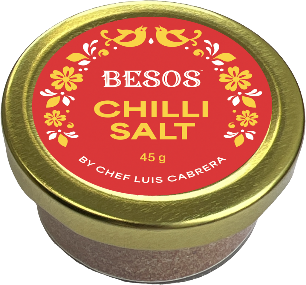 Jar of Besos Chilli Salt by Chef Luis Cabrera with a red label and gold lid.