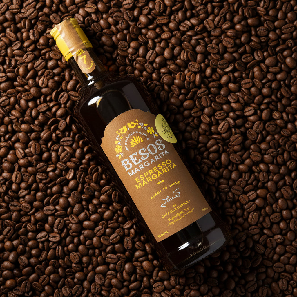 Load image into Gallery viewer, Bottle of Besos Espresso Margarita on a bed of coffee beans