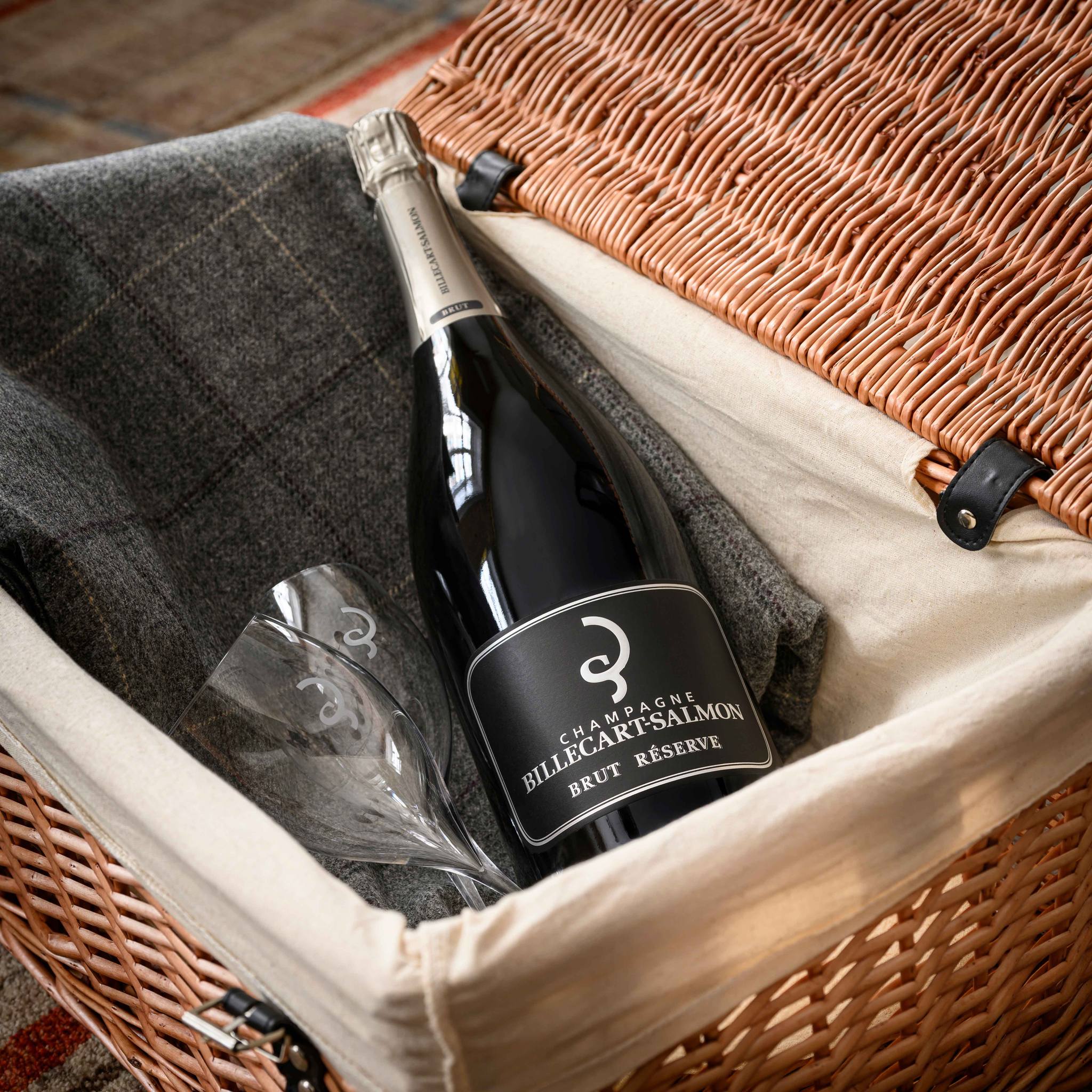 Load image into Gallery viewer, Bottle of Billecart-Salmon Le Reserve Champagne in a wicker picnic basket with a glass.
