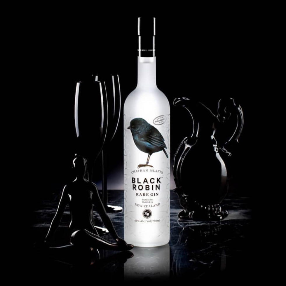 Black Robin Rare Gin bottle with decorative elements on a black background