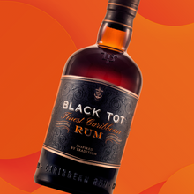 Load image into Gallery viewer, Bottle of Black Tot rum on an orange background