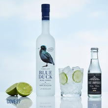 Load image into Gallery viewer, Bottle of Blue Duck vodka with a glass of lime and ice, and East Imperial sake on a reflective surface.