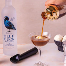 Load image into Gallery viewer, Blue Duck vodka bottle with a cocktail being poured into an espresso martini topped with ice cream