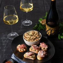 Load image into Gallery viewer, A bottle of Bogle Phantom Chardonnay, wine glasses and food on a plate on a black wooden table