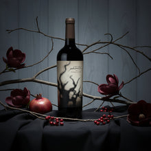 Load image into Gallery viewer, Bogle Phantom Proprietary Red Blend Wine bottle with decorative flowers and branches on a dark surface