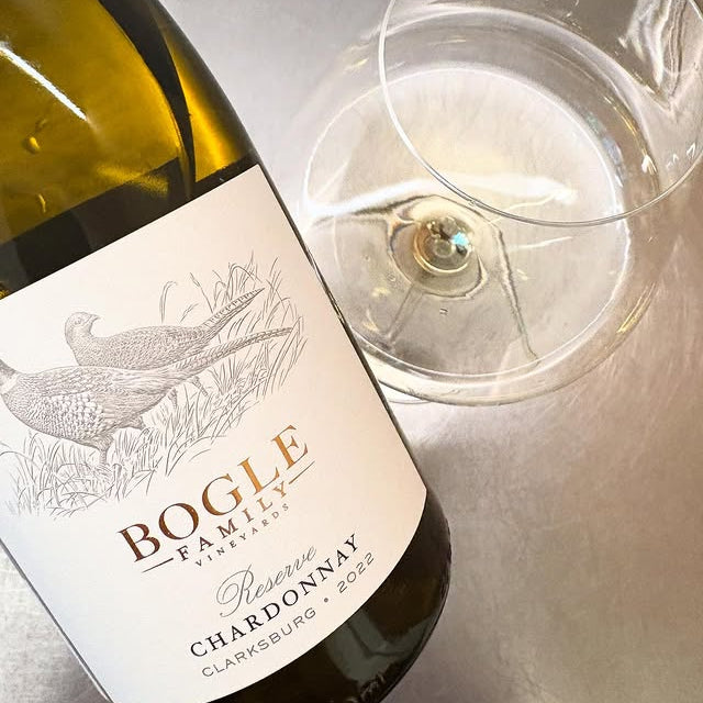 Bottle of Bogle Reserve Chardonnay with a wine glass on a reflective surface
