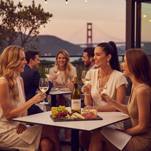 Load image into Gallery viewer, Three women enjoying a bottle of Bogle Reserve Chardonnay in a San Francisco restaurant with the Golden Gate Bridge in the background.