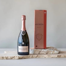 Load image into Gallery viewer, Bollinger rosé champagne bottle and packaging on a marble slab with a plain background