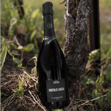 Load image into Gallery viewer, Bottle of prosecco leaning against a tree in a natural setting