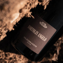 Load image into Gallery viewer, A bottle of prosecco on a textured surface