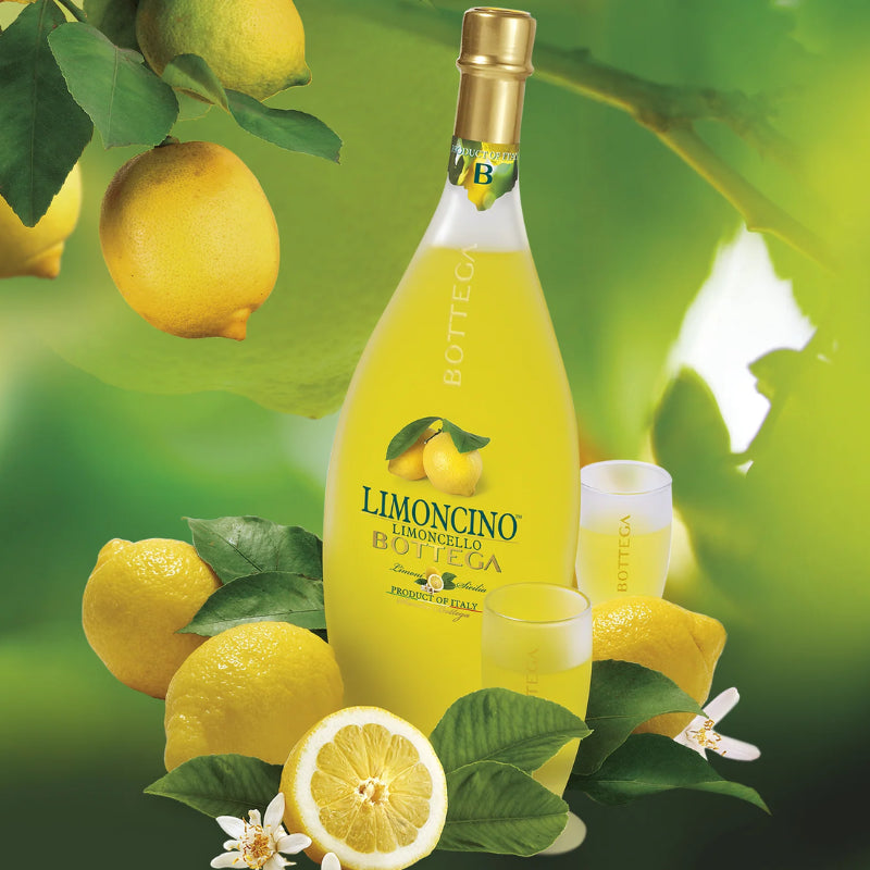 Bottle of Bottega Limoncino surrounded by lemons and a glass on a green background