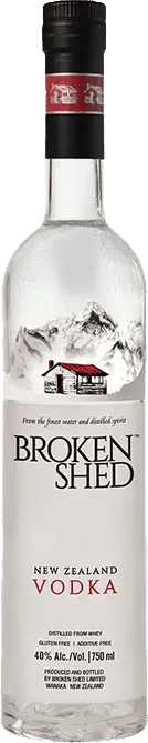 A bottle of Broken Shed New Zealand Vodka on a plain white background. The clear glass bottle shows the transparent liquid inside, with a black cap and a white label featuring a red house graphic and the brand name 'BROKEN SHED' in large black letters.
