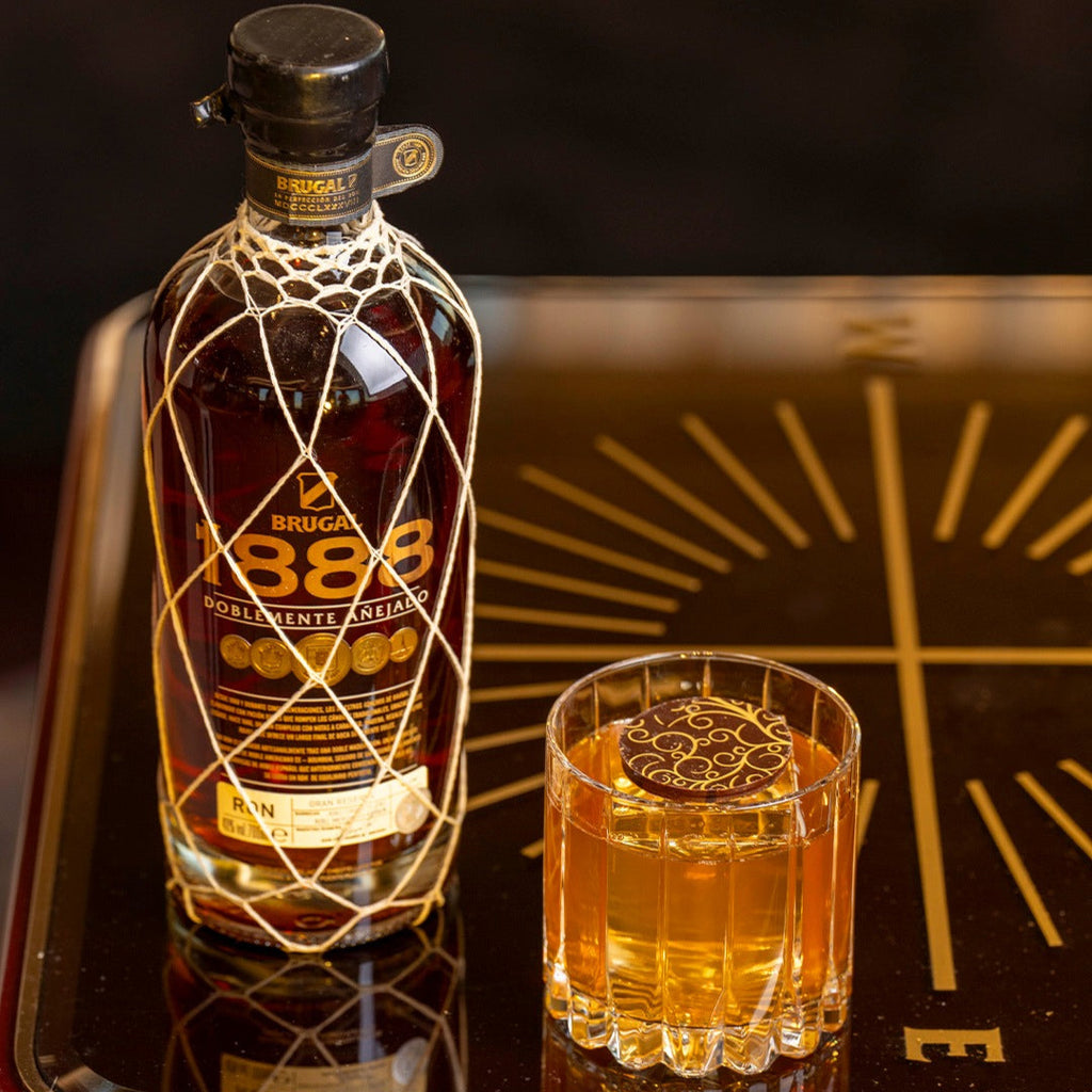 Brick 1888 rum bottle and glass on a decorative tray with 'Enjoy Responsibly' text.
